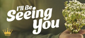 Promotional graphic for Hallmark's 2026 film "I'll Be Seeing You," featuring smiling man Tyler Hynes as Mark Appleyard and Stacey Farber as Amy standing on either side of a small vintage-style van named Mable, set against a warm circular yellow and orange background.