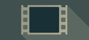A flat design illustration of a film strip with a dark teal screen and a beige border, casting a long shadow to the right against a muted green background.
