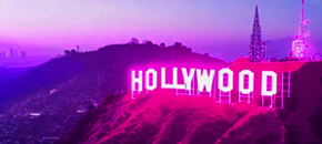 The Hollywood sign illuminated at night, stylized with a vibrant neon purple and pink aesthetic, overlooking a sprawling cityscape under a glowing gradient sky.