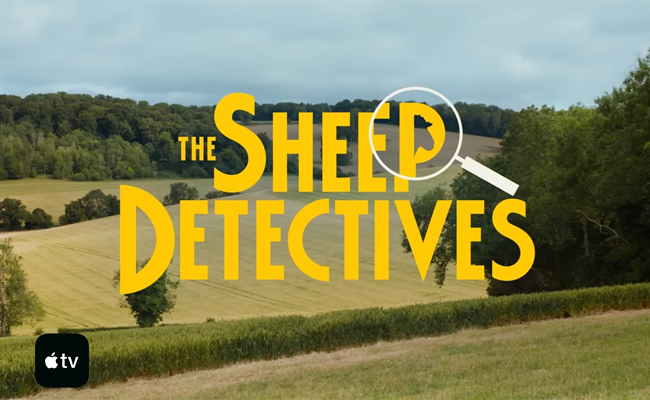 Title card for "The Sheep Detectives" with yellow text superimposed on a pastoral landscape, featuring a magnifying glass over the letter 'P' which contains a sheep's silhouette, and an Apple TV logo in the lower left corner.